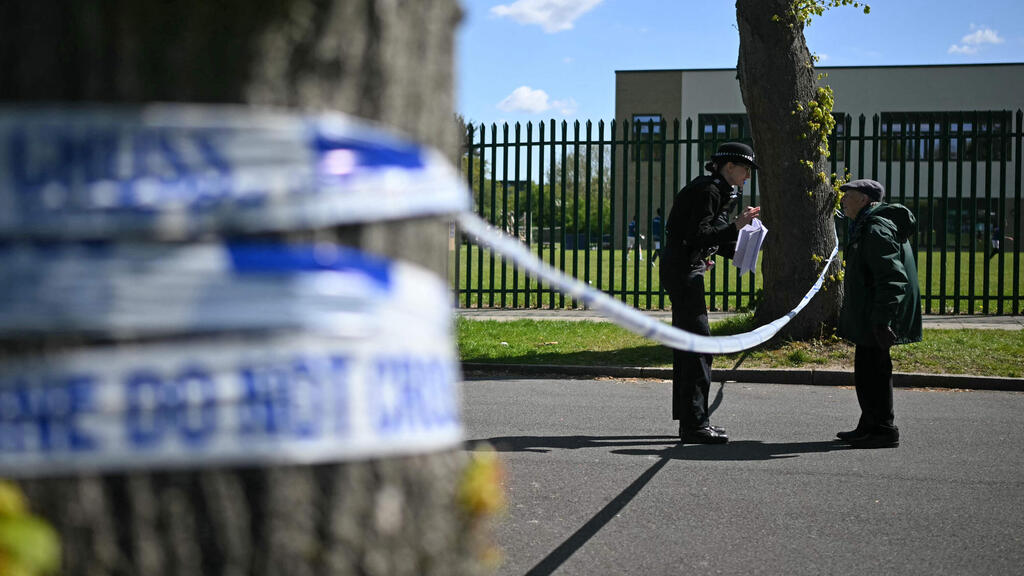 שוטרת משוחחת עם אזרח ליד בית הכנסת