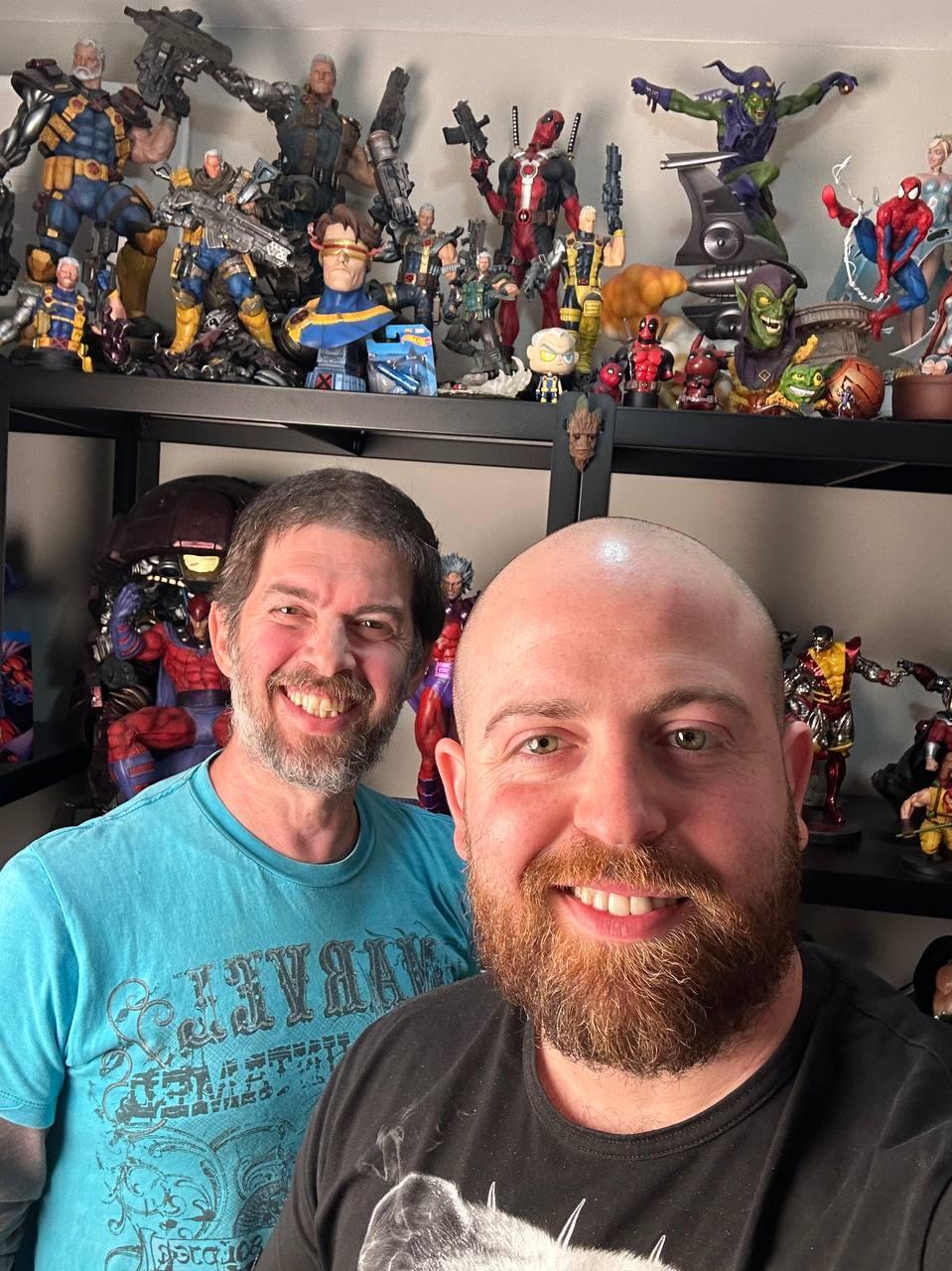 Eitan, left, poses with Bar Gindy, host of the People & Collectors podcast, in Eitan’s collection room, where shelves are lined with comic books, statues and pop-culture memorabilia at his home 