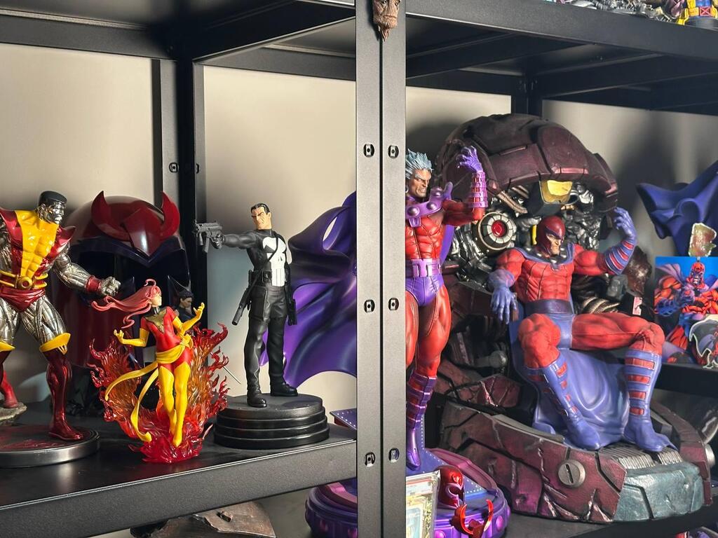 Statues and busts from comic-book characters are displayed on shelves in Eitan’s collection room 