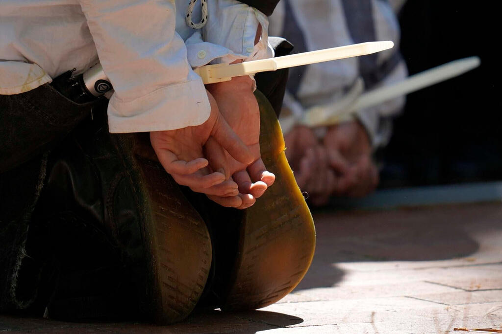 Protesters are cuffed after being detained on the campus of Emory University during a pro-Palestinian demonstration on April 25, 2024 