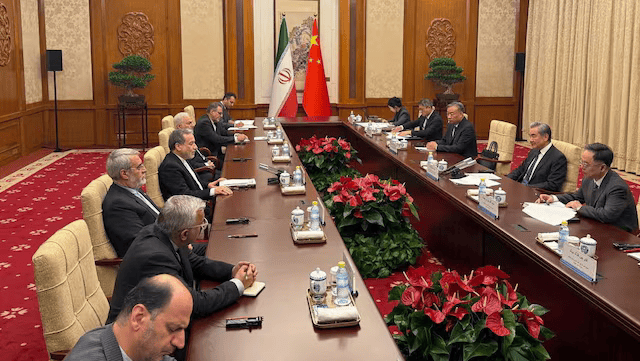 Iranian Foreign Minister Abbas Araqchi meets with Chinese Foreign Minister Wang Yi in a location given as Beijing, China, in this handout 