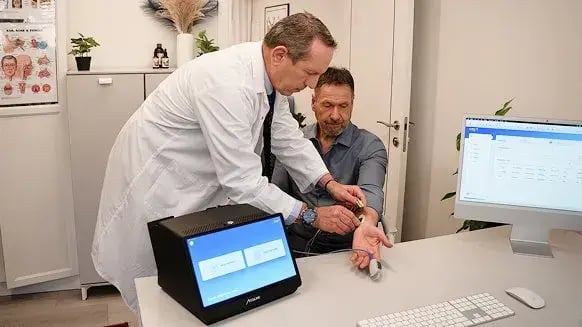 A doctor and his patient with Acculine's CORA device