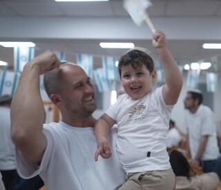 Families gather inside the new Be’er Shalom synagogue in Shlomit, celebrating the community’s growth and resilience after the Oct. 7 attacks 