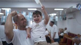 Families gather inside the new Be’er Shalom synagogue in Shlomit, celebrating the community’s growth and resilience after the Oct. 7 attacks 