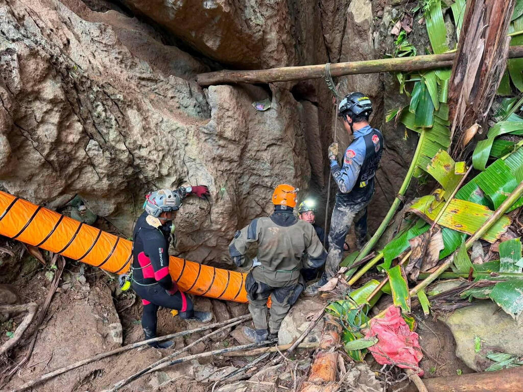  Members of a rescue team work to save seven people trapped in a cave in Xaisomboun Province, Laos; 5 of the trapped were reported to be found alive 