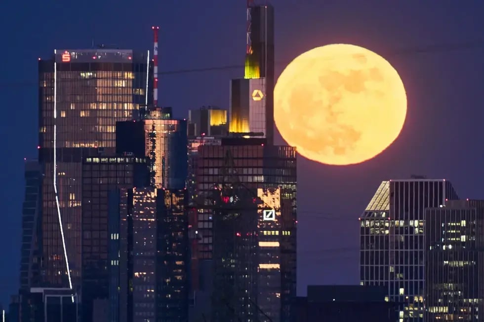 The full moon rises behind the buildings of the banking district in Frankfurt, Germany (Photo: AP) The full moon rises behind the buildings of the banking district in Frankfurt, Germany