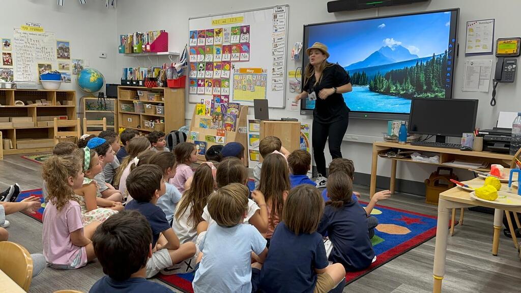 Speech-language therapist Moran Goldschmidt leads activities with children during one of her educational programs, which grew out of the online storytime initiative she launched after Oct. 7 (Photo: Courtesy) Moran Goldschmidt