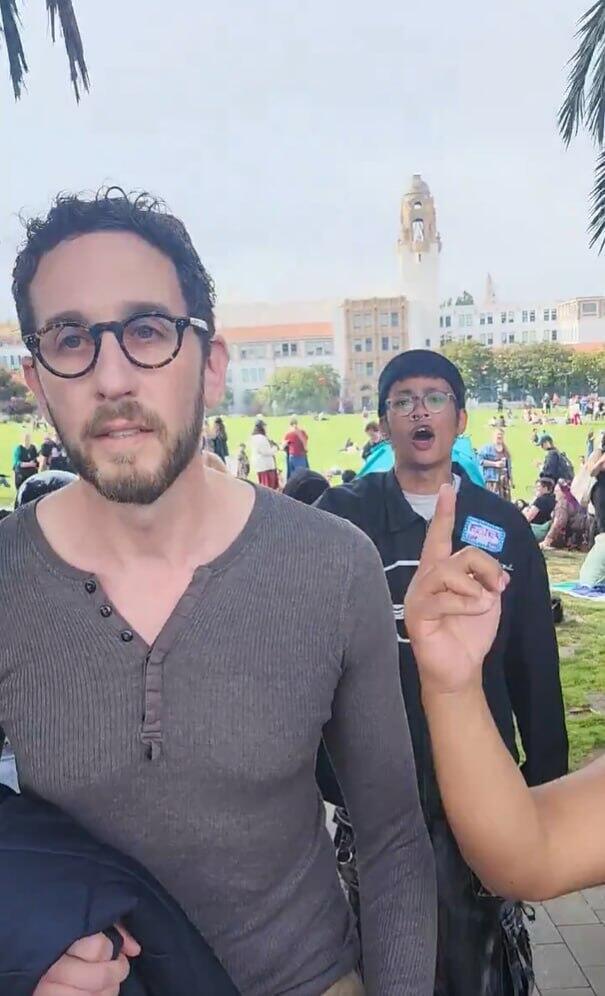 Other demonstrators are also seen pursuing Wiener in front of stunned parade participants 