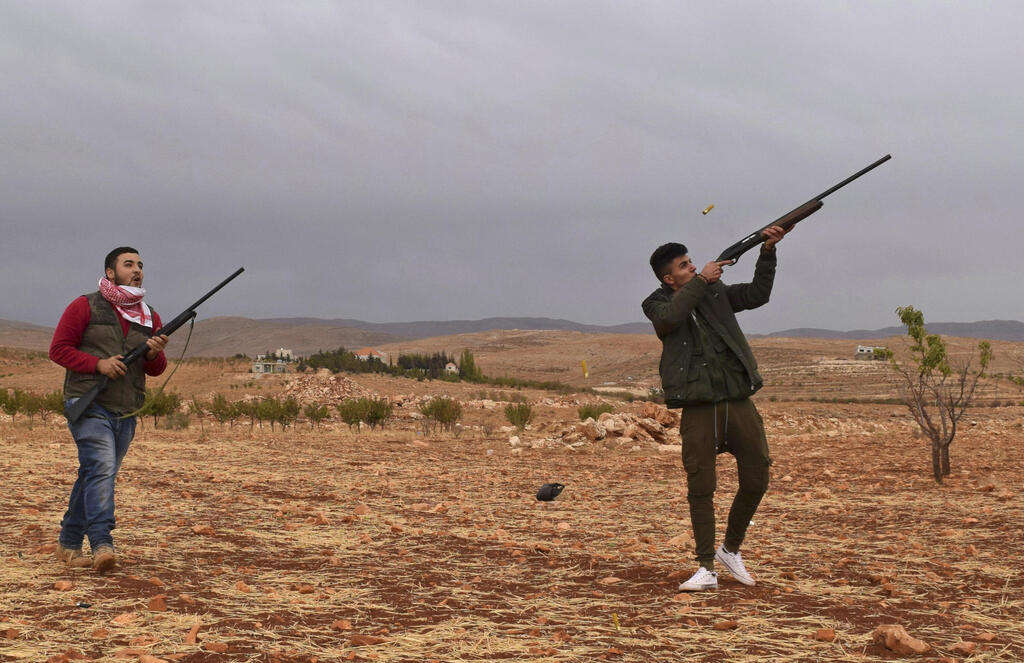 Lebanese bird poachers (Photo: Philip Issa/AP) ציידי ציפורים בלבנון