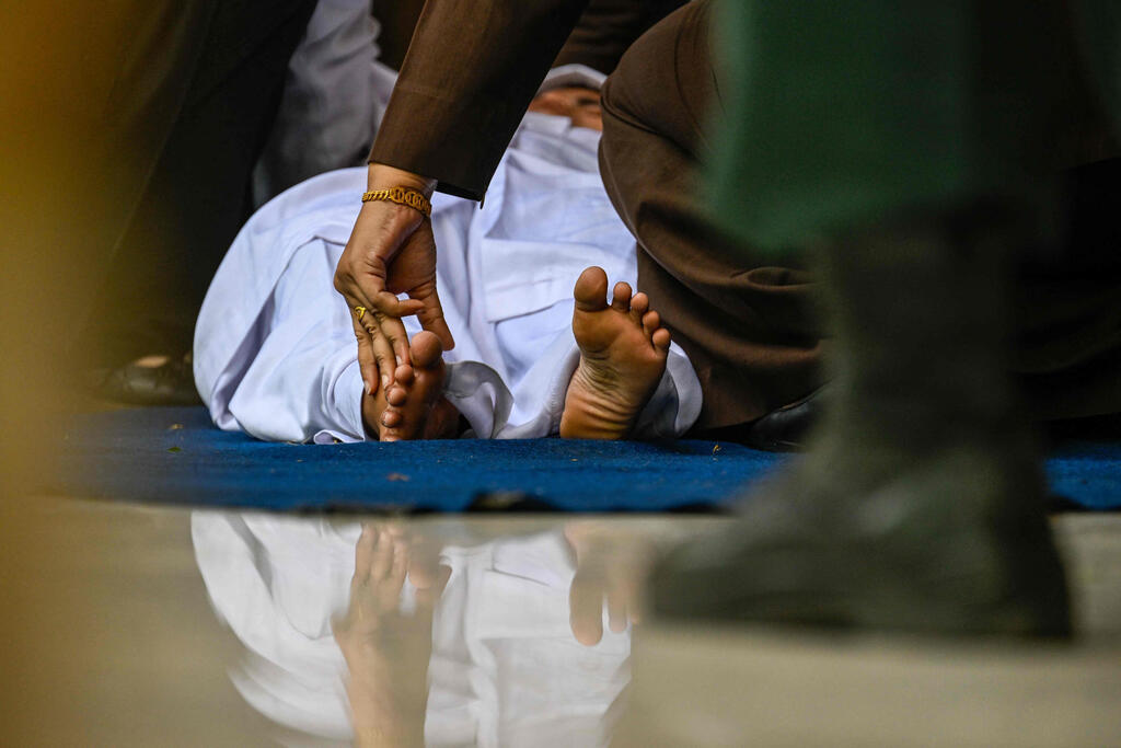 Photo: CHAIDEER MAHYUDDIN / AFP הלקאה פומבית ב אינדונזיה