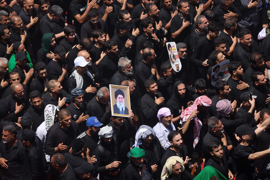 Photo: AHMAD AL-RUBAYE / AFP הלוויתו של עלי חמינאי