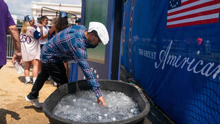 An visitor collects a bottle of cold water while attending the Great American State Fair on the National Mall, Wednesday, July 1, 2026, in Washington 