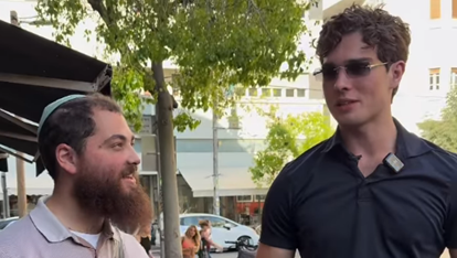 Rabbi Yossi Farro, left, accompanies viral influencer Clavicular as the pair tour Tel Aviv during Clavicular's first visit to Israel 