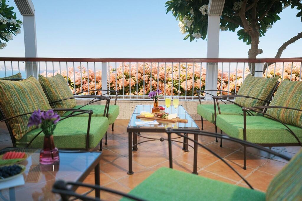 A private terrace at one of the hotel's premium suites, offering outdoor seating and views toward the Red Sea (Photo: Dan Hotels) A private terrace at one of the hotel's premium suites, offering outdoor seating and views toward the Red Sea