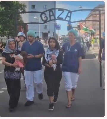 Protesters in Stockholm hold a replica of the Auschwitz entrance gate, replacing the inscription 'Arbeit Macht Frei' with the word 'Gaza' (Photo: from social media) השער עם הכיתוב "עזה" בהפגנה בשטוקהולם