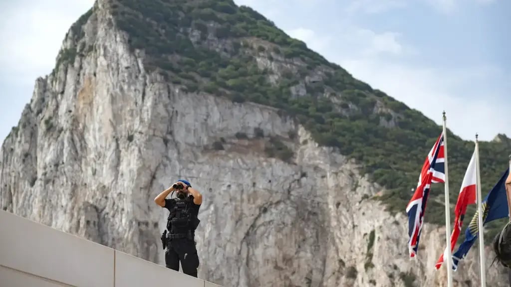 A Spanish police officer (Photo: Marcos Moreno/AP) A Spanish police officer uses a pair of binoculars on the first day of passport-free travel under a new EU-U.K. treaty, at the border crossing between Gibraltar and Spain in La Línea de la Concepción, Spain, Wednesday, July 15, 2026