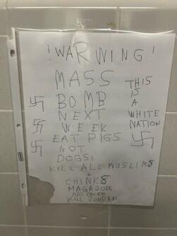 Fang, 30, allegedly posted this message on a men’s restroom wall at the university in November 2025 (Photo: US Department of Justice) מכתב האיום שהדביק החשוד בשירותים