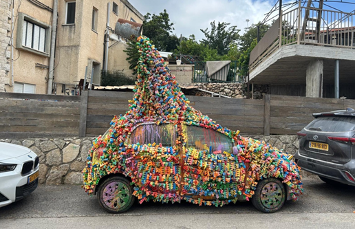 Artist Sam Halaby's paint-covered car sits outside his House of Colors in Daliyat al-Karmel, where it serves as both transportation and a mobile work of art (Photo: Yael Feldman Shavit) Artist Sam Halaby's paint-covered car sits outside his House of Colors in Daliyat al-Karmel, where it serves as both transportation and a mobile work of art