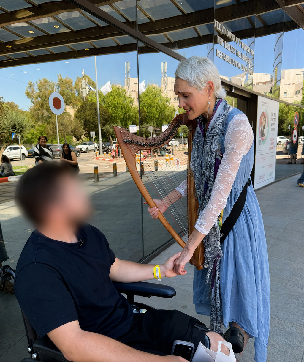 Cydney Galbraith playing her harp for wounded IDF soldier at Sheba Hospital 