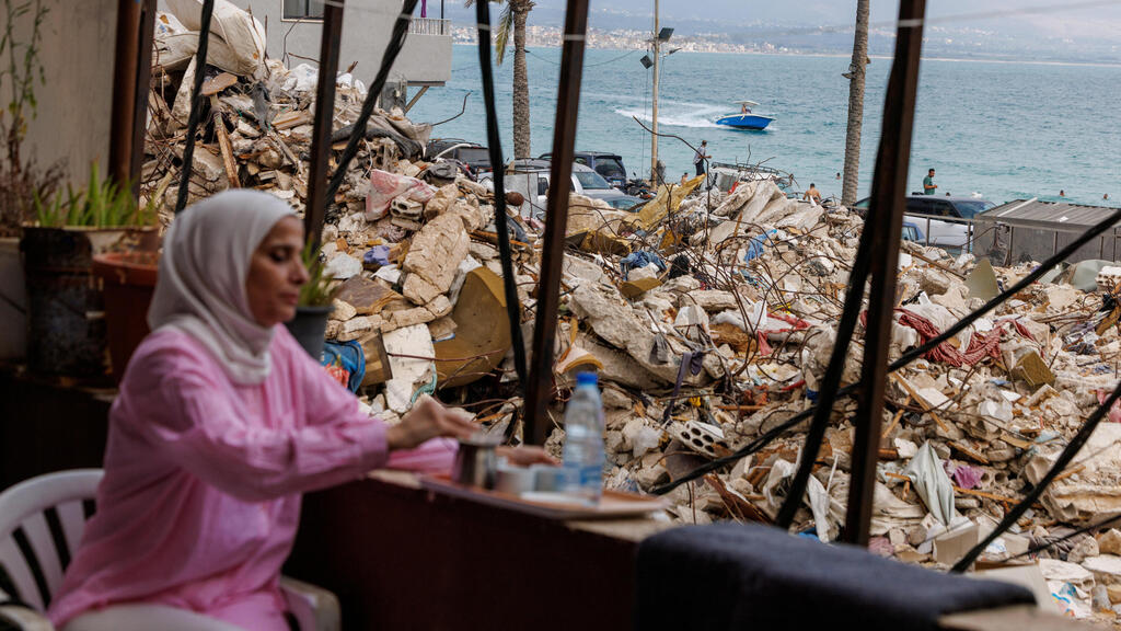  A Lebanese woman sits in her house next to the ruins in Tyre - facing the beach 