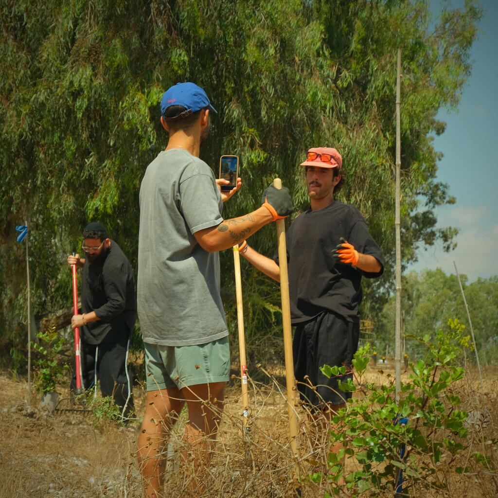 Australian runner and content creator Joel Solomon, center, is filmed during a volunteer activity in Israel as part of Birthright Israel’s Storytellers program (Photo: Courtesy) Australian runner and content creator Joel Solomon, center, is filmed during a volunteer activity in Israel as part of Birthright Israel’s Storytellers program