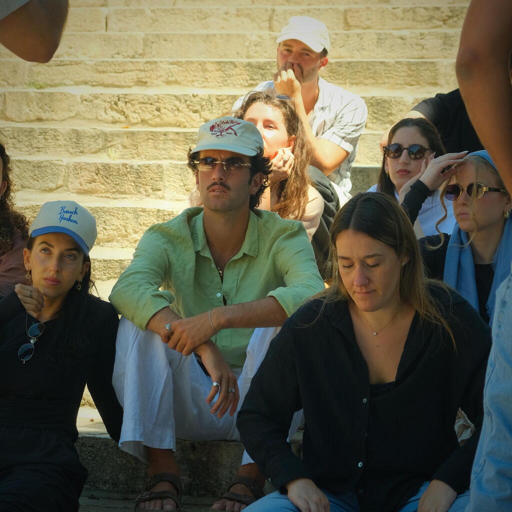 Joel, seated near the center, listens during a visit to Jerusalem’s Old City (Photo: Courtesy) Joel, seated near the center, listens during a visit to Jerusalem’s Old City