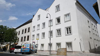Vehicles are parked outside the building where Adolf Hitler was born, which has been converted into a police station by Austria's government in hopes of preventing it from serving as a place of ‌pilgrimage for neo-Nazis, in Braunau am Inn, Austria, July 16, 2026 