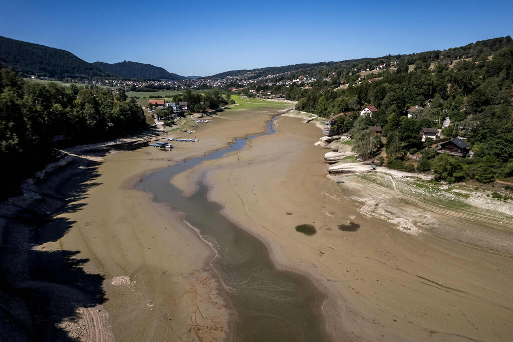 Aerial view of the dry lakebed of Lake des Brenets (Photo: Fabrice Coffrini / AFP) מבט אווירי על הקרקעית היבשה של אגם ברנה