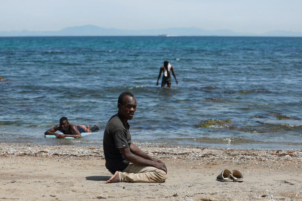 A migrant who arrived from Morocco prays on the sand in the Spanish enclave (Photo: REUTERS/Violeta Santos Moura) A migrant who arrived from Morocco prays on the sand in the Spanish enclave