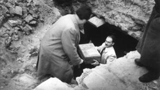 Workers recover part of the Oyneg Shabes Archive from beneath the ruins of the former Warsaw Ghetto after World War II. The clandestine collection of nearly 35,000 documents was buried by Jewish historians to preserve a firsthand account of the Holocaust 