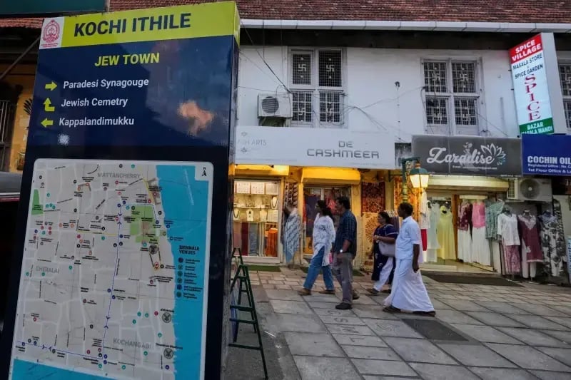 Visitors walk past a sign featuring a map of Kochi and details about the Paradesi Synagogue and the Jewish cemetery in the historic Jew Town neighborhood (Photo: AP Photo/Aijaz Rahi) Visitors walk past a sign featuring a map of Kochi and details about the Paradesi Synagogue and the Jewish cemetery in the historic Jew Town neighborhood