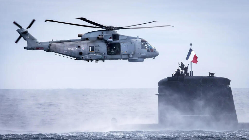 A British Merlin helicopter and a French submarine meet during an exercise (Photo: mod.uk) A British Merlin helicopter and a French submarine meet during an exercise