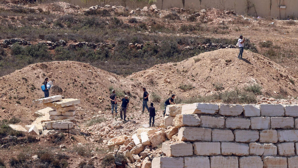 מתנחלים מול בתי פלסטינים בכפר קוסרה