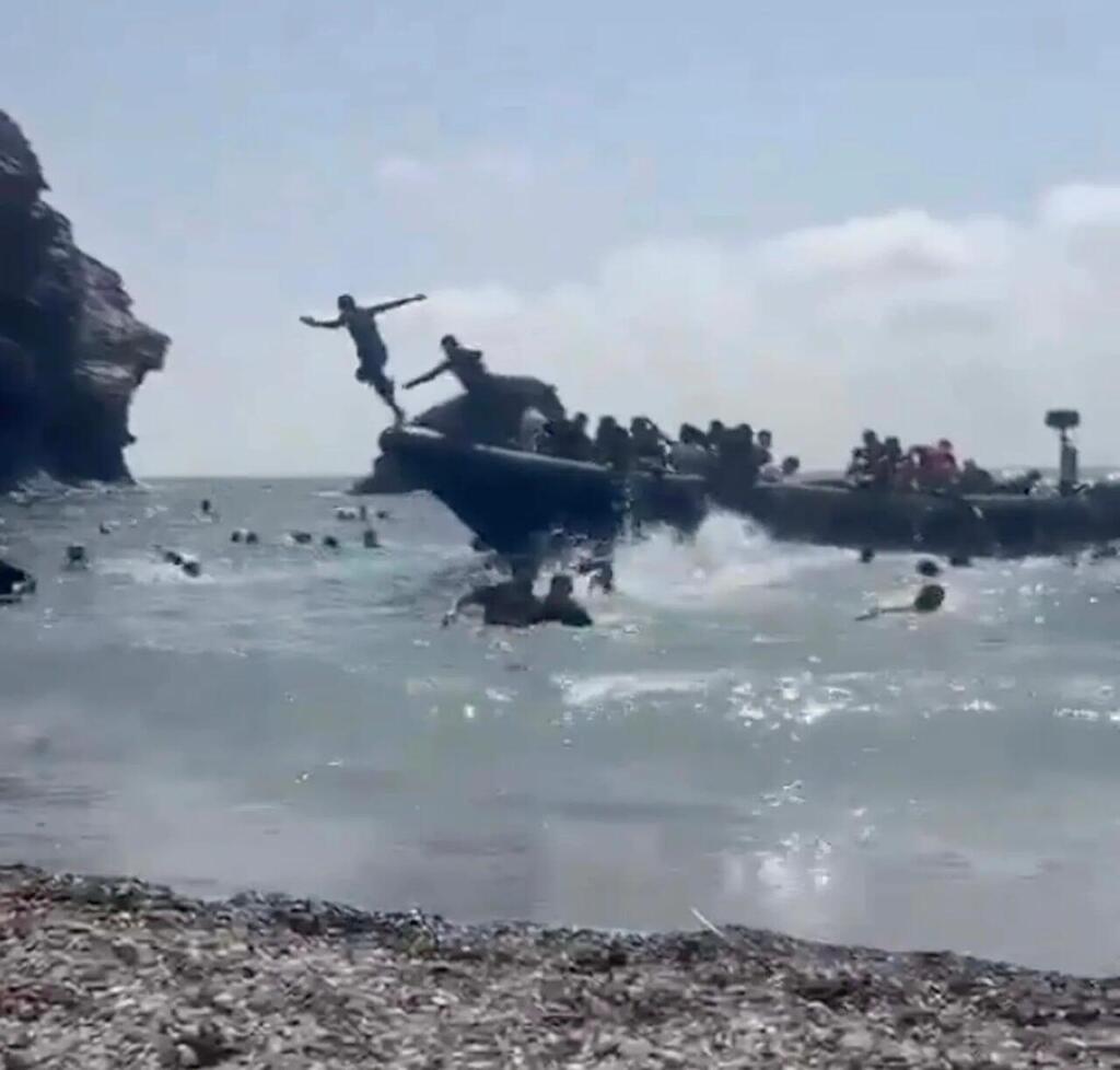 ספרד סירת מהגרים מגיעה לחוף מלא תיירים מורסיה