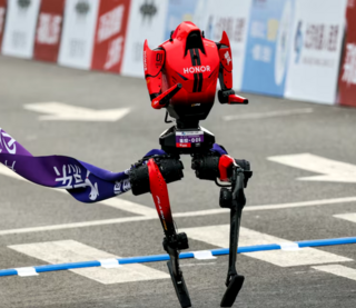 A Lightning humanoid robot by Honor crosses the finish line of the second Beijing E-Town Half Marathon and Humanoid Robot Half Marathon in Beijing 