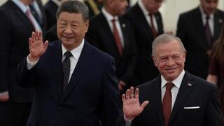 China’s President Xi Jinping (L) and King Abdullah II of Jordan (R) gesture after attending a welcoming ceremony at the Great Hall of the People in Beijing, China 
