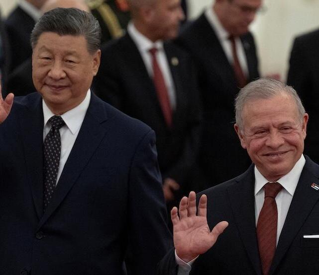 China’s President Xi Jinping (L) and King Abdullah II of Jordan (R) gesture after attending a welcoming ceremony at the Great Hall of the People in Beijing, China 