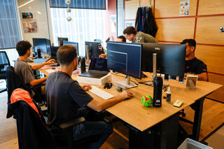 Workers at Israeli startup Gambit Security sit at their desks at the company's offices in Tel Aviv 