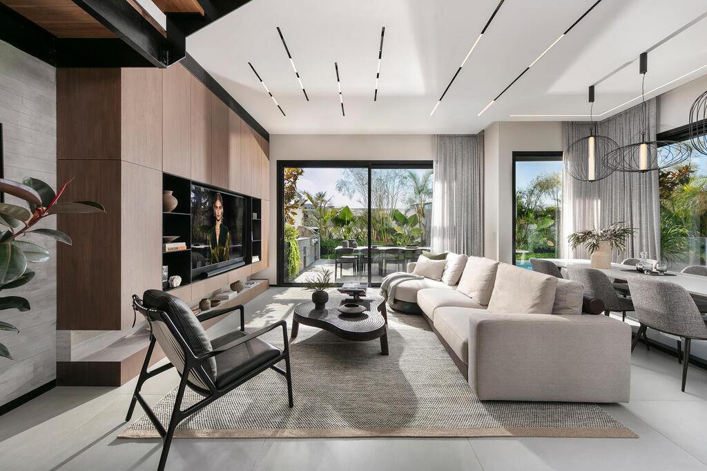 The living room, dining area and greenery surrounding the interior (Photo: Elad Gonen) בית פרטי באבן יהודה, עיצוב פנים: ליעד יוסף