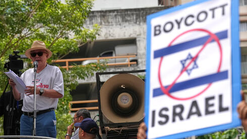 סונדהי לימטונגקול, איש תקשורת ופעיל פוליטי, נואם מול תומכיו בהפגנה מול שגרירות ישראל בבנגקוק