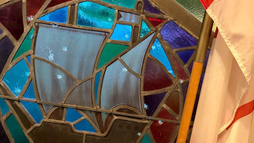 23 bullet holes in the window of Ontario's B’nai Jacob synagogue בית הכנסת "בני יעקב" באונטריו