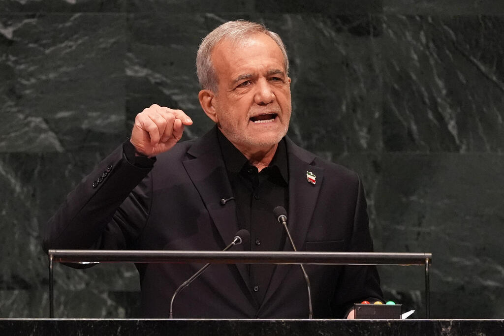 Iran's President Masoud Pezeshkian speaks as he holds a picture of Ali Khamenei, former Supreme Leader of Iran, during the 81st United Nations General Assembly at the United Nations Headquarters in New York, on September 23, 2026 