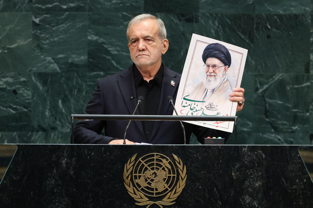 Iran's President Masoud Pezeshkian speaks as he holds a picture of Ali Khamenei, former Supreme Leader of Iran, during the 81st United Nations General Assembly at the United Nations Headquarters in New York, on September 23, 2026 