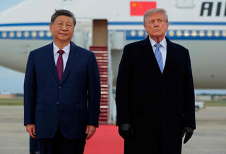 US President Donald Trump and Chinese President Xi Jinping look on during an arrival ceremony a Joint Base Andrews, Maryland 