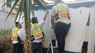 MDA medics finish building a sukkah after treating its owner, who was struck by a metal pole during construction 