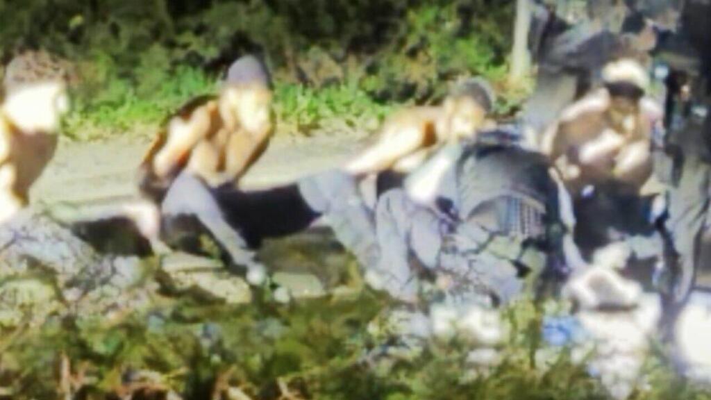 The five terrorists, stripped to the waist on the sidewalk, are searched by security forces early yesterday morning (Photo: X) בריטניה חשד ל מזימת טרור ש סוכלה בסיס חיל האוויר פיירפורד תיעוד ה עצורים