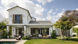 The home’s rear façade opens onto a landscaped garden, swimming pool and outdoor entertaining areas 