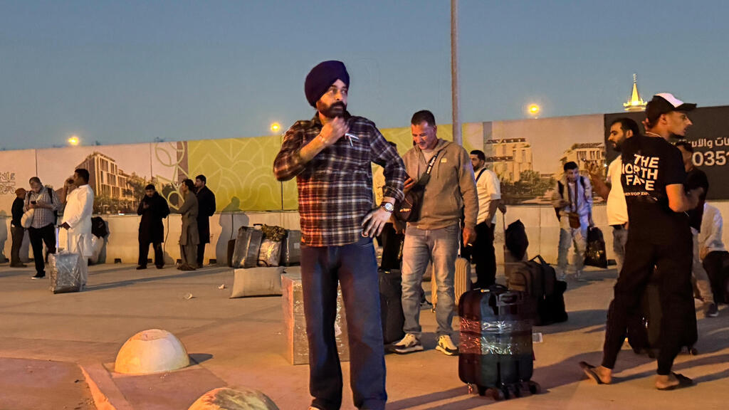 People gather near Riyadh airport after an attack that killed nationals of several countries (Photo: AP) ריאד