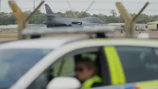 A B1 bomber prepares to take off as police officers guard a checkpoint near RAF Fairford air base, in Fairford, England, Tuesday, Sept. 29, 2026 