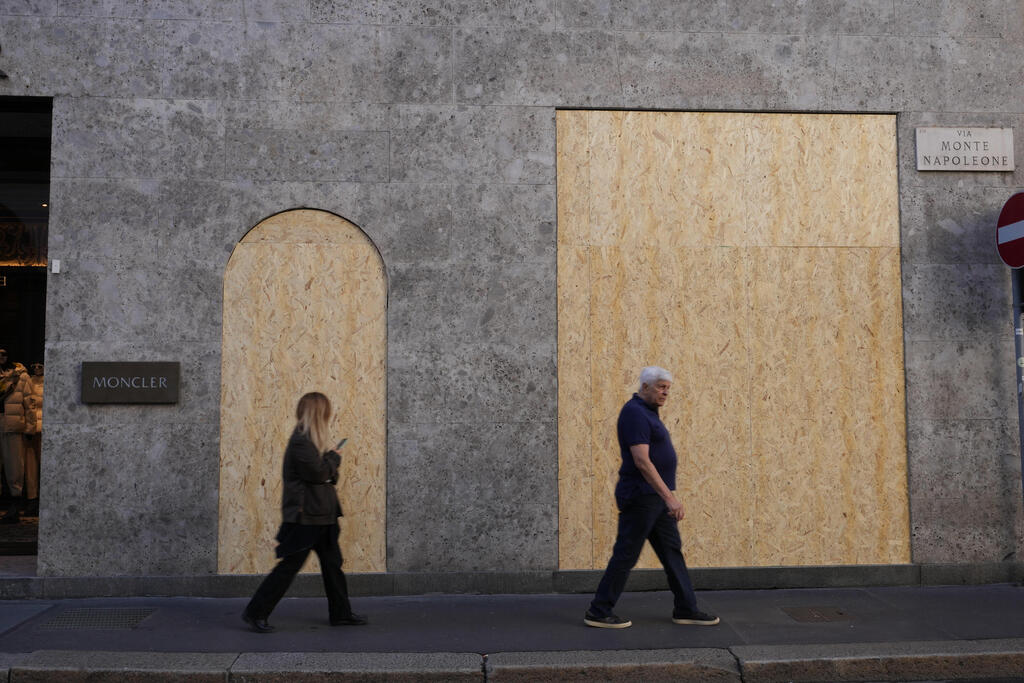 Shops in Milan's luxury shopping district board up their windows ahead of demonstrations (Photo: AP Photo/Antonio Calanni) איטליה הפגנה מפגינים מילאנו ב שבת